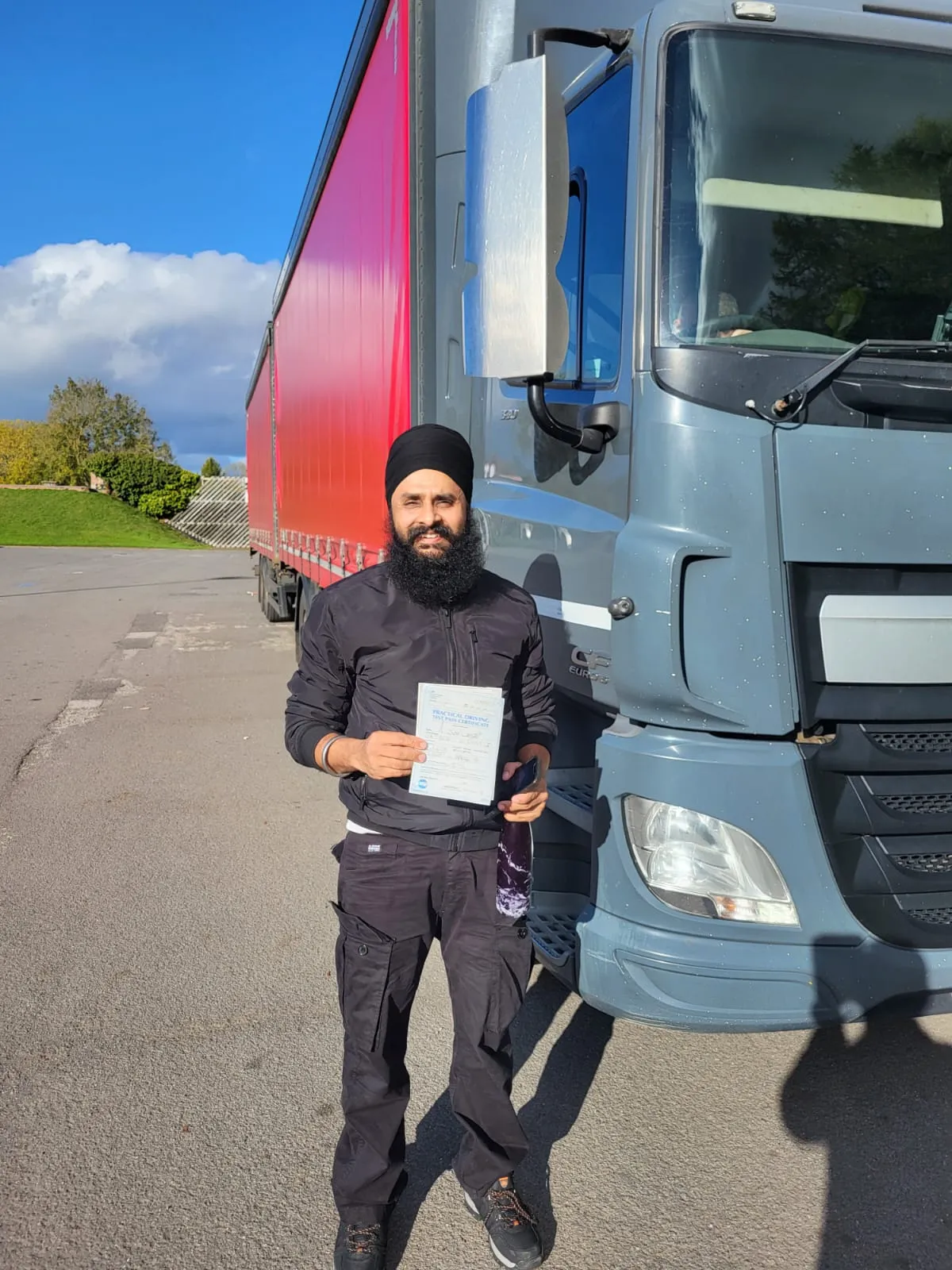 A man standing in front of a semi truck.