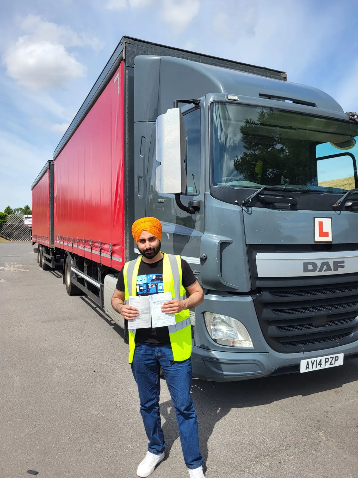 A man standing in front of a large truck.